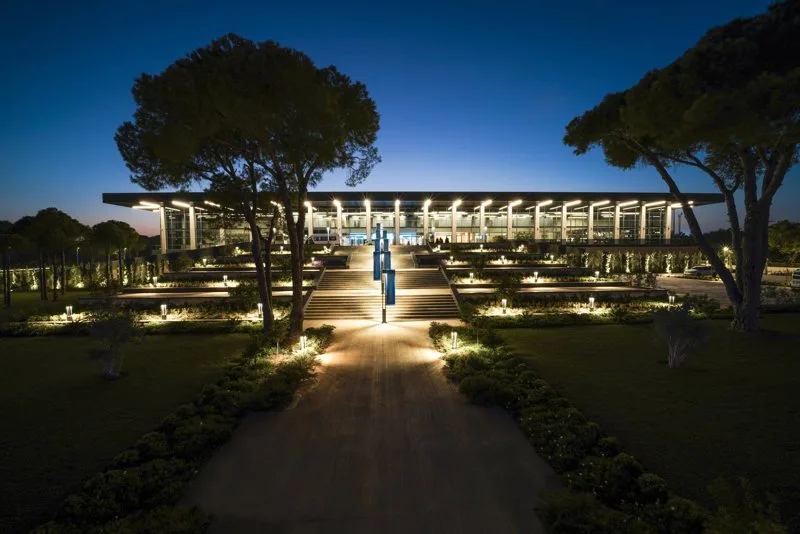 The approach to the NEST Convention Center at night.